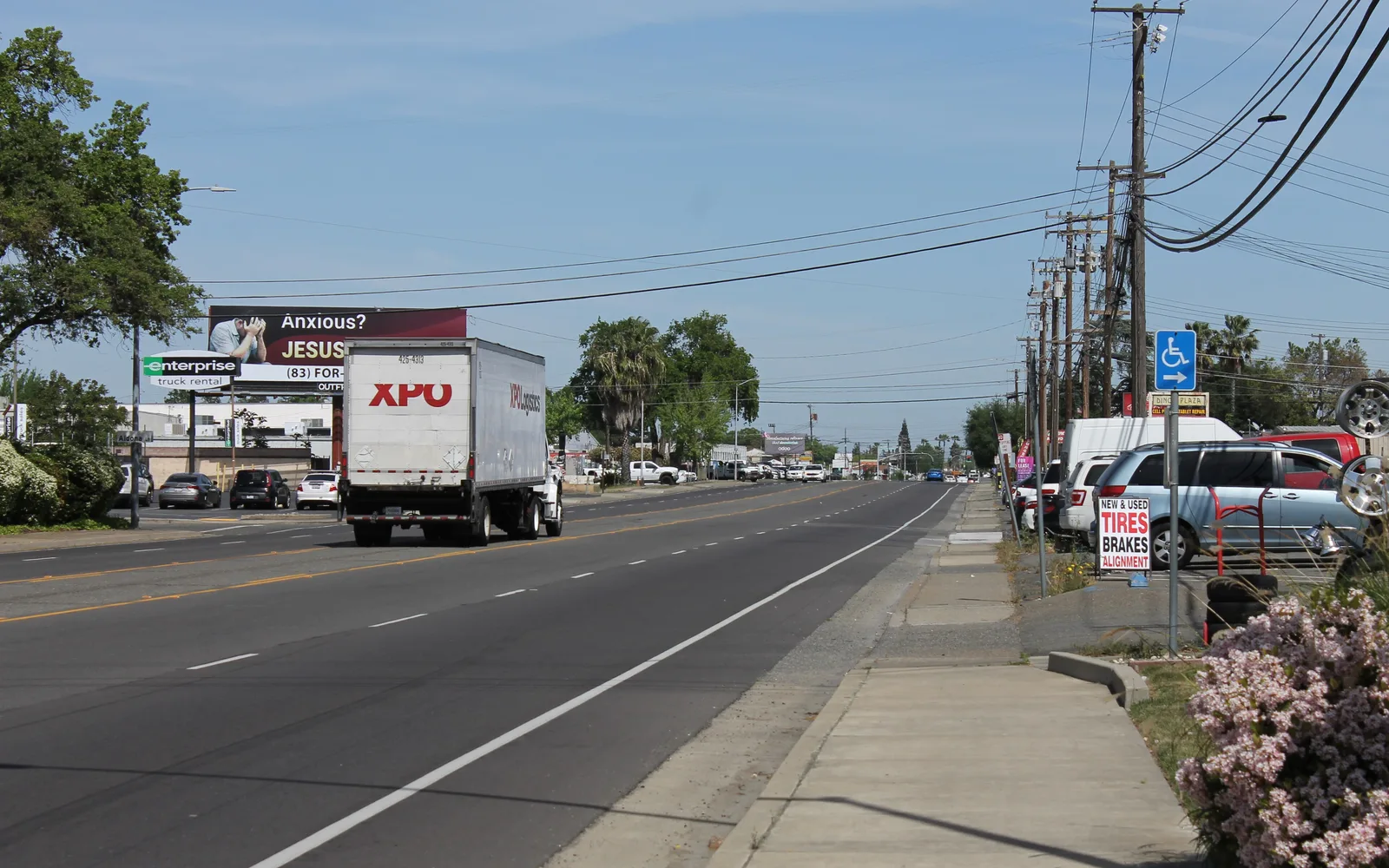 Auburn Boulevard near Orange Grove Avenue in Sacramento, showing a suburban street with trees and power lines